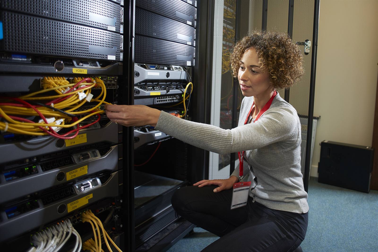 IT engineer reviewing server room infrastructure