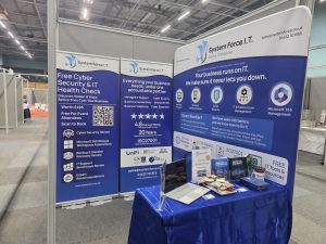The System Force IT stand on Stand 18 at the Chamber Business Expo 2026, with the free Cyber Security and IT Health Check banner